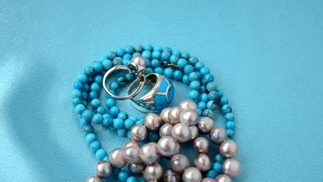 Beads from pearls. Shooting on blue silk