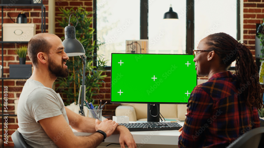 Poster diverse colleagues working with greenscreen display on computer, analyzing isolated chroma key on bl