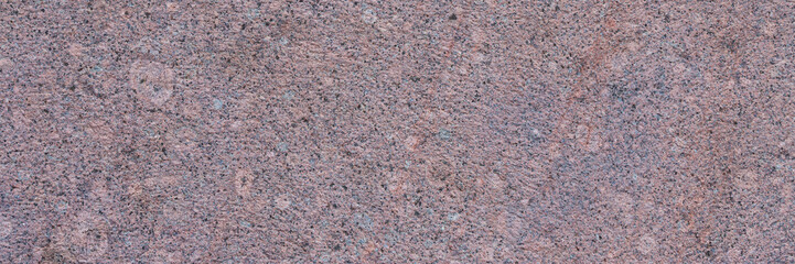 Granite texture. Natural pink granite with a grainy pattern. Stone background. Solid rough surface...