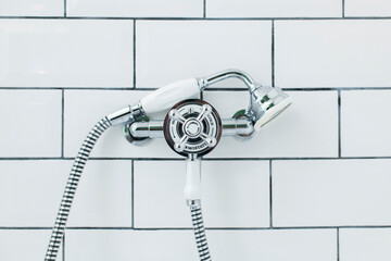 close up of a shower head and tap