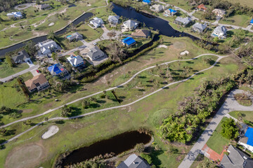 Hurricane Ian destroyed homes in Florida residential area on golf course. Natural disaster and its consequences