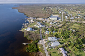 Fototapeta premium Hurricane Ian destroyed homes in Florida residential area on golf course. Natural disaster and its consequences