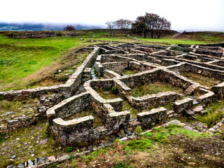 ruins of an old pre-Roman town on top of a green mountain in Galicia. Castrexo settlement of Castromaior. Santiago's road. Galicia - obrazy, fototapety, plakaty