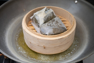 steaming traditional Cantoness food named sticky rice wrapped with lotus leaf