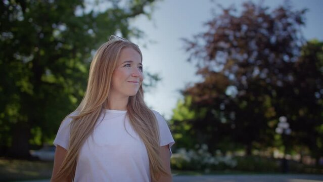 Happy young girl walks through city park, vancouver island, victoria