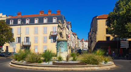 Summer view of Riom cityscape overlooking fountain erected in honor of General Desaix with...