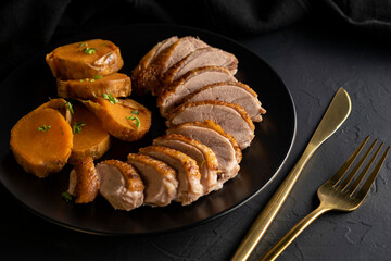Christmas Roast duck with sweet potato on dark background