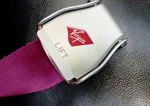 detail of the buckle of the seat belt with the logo of Virgin Atlantic on an empty seat