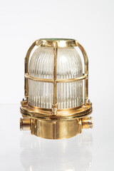 Old brassy ship lantern on white