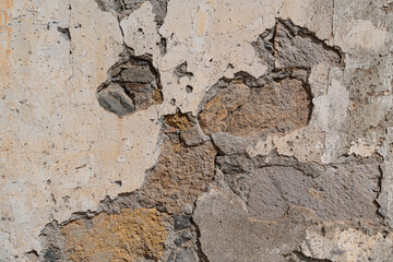 Texture of a deteriorated stone and cement wall