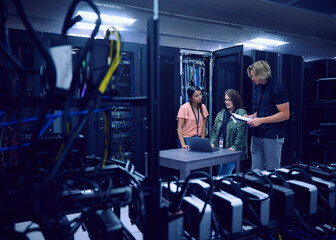 Team of technicians working in server room