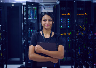 Portrait of smiling female technician in server room