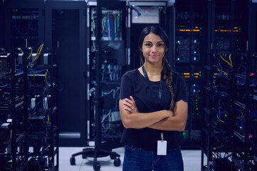 Portrait of smiling female technician in server room