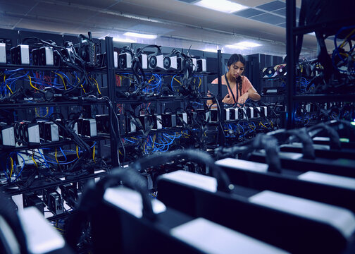Female technician working in server room