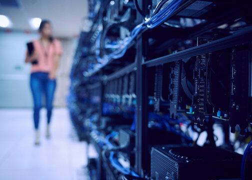 Female technician working in server room