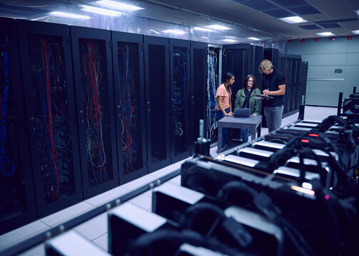 Team of technicians working in server room