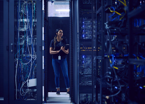 Female technician working in server room
