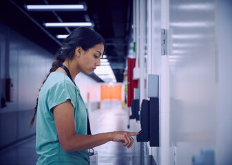 Woman using digital fingerprint scanner in office