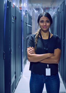 Portrait of smiling female technician standing in server room
