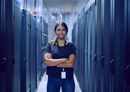 Portrait of smiling female technician standing in server room