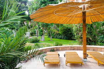 Egypt, Luxor, Temple of Dendarah, Sunbeds and sunshade in luxury tourist resort