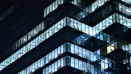 Modern office building in city at the night. View on illuminated offices of a corporate building....