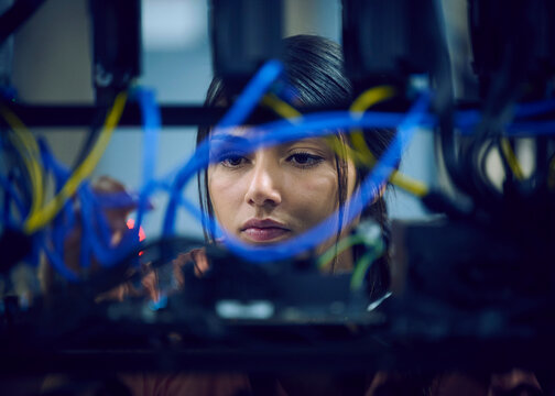 Close-up of female technician working in server room