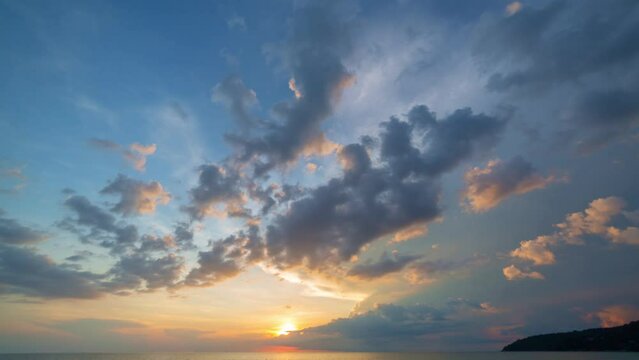 .time lapse scenery sunset above the ocean clouds cover the ocean during colorful .cloud in sunset on Karon beach Phuket Thailand. .video 4K. Scene of Colorful red light in the sky background.