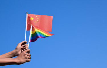 Rainbow flag and National flags of China, soft and selective focus, concept for LGBT celebration and respecting gender diversity of human in China and around the world.