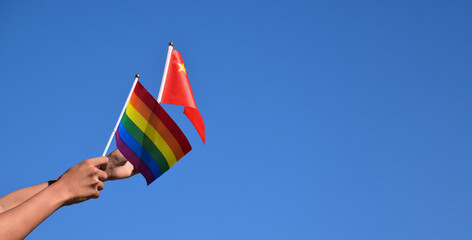 Fototapeta premium Rainbow flag and National flags of China, soft and selective focus, concept for LGBT celebration and respecting gender diversity of human in China and around the world.