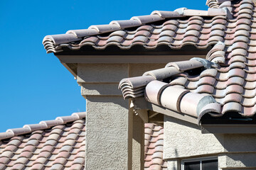 An Arizona house tile roof on a blue sky