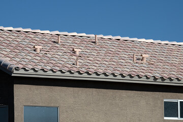 An Arizona house tile roof on a blue sky