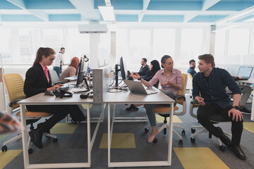 Collaborative process of multicultural skilled young business team during brainstorming meeting in office.Diverse group of young people dressed in formal wear cooperating on developing design project