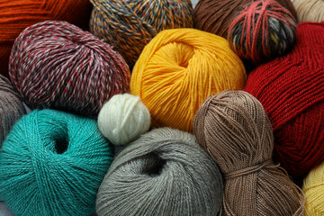 Many different soft woolen yarns as background, closeup