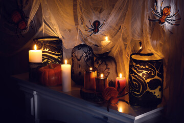 Different Halloween decor on fireplace indoors. Festive interior