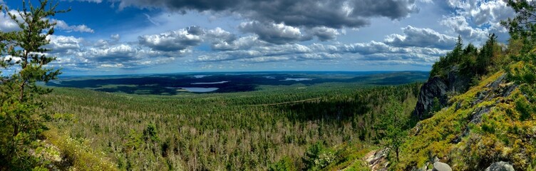 Panoramic photo off mountain top overlooking lakes and forest