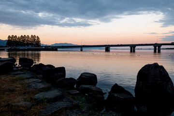 Fototapeta premium 琵琶湖のオレンジの夕焼けを背景にした近江大橋