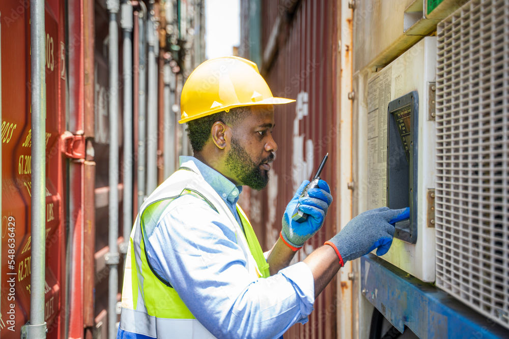 Poster engineer using walkie talkie checking stock into container for loading,international shipping logist