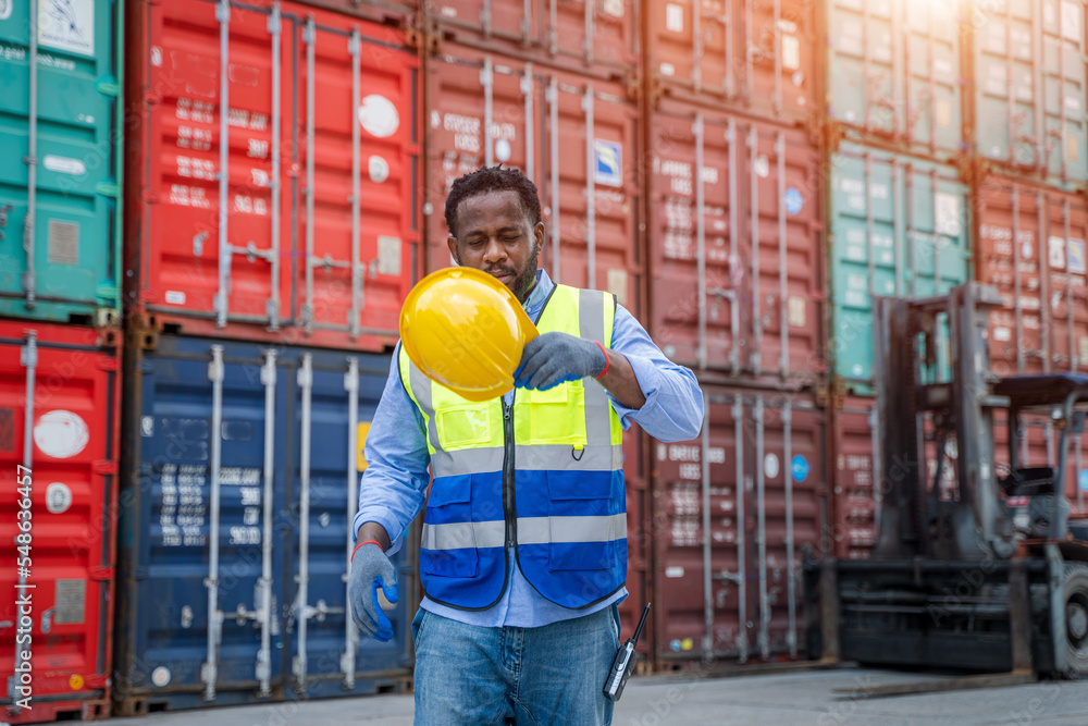 Poster technician working and inspecting cargo container in shipping yard,container shipping logistics conc