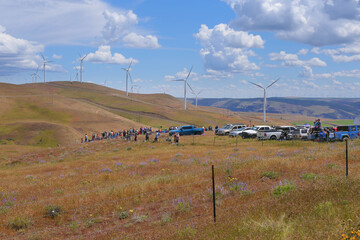 observation deck in the field. Machines and people the background of a yellow field, blue sky and clouds