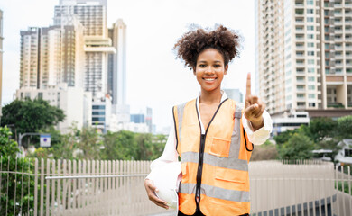 African-American construction worker shows a finger thumbs up in the final stage of the reconstruction of the facility. Happy black worker in helmet First engineer leader industrial.Architect project.