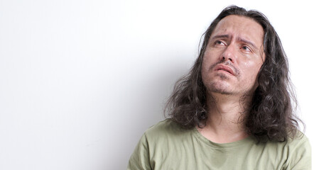 Fototapeta premium face of depressed latin man looking up while crying with tears