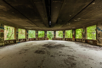 Normandy, France: derelict dining room in abandoned building of a former sanatorium, overgrown with vegetation, risk of asbestos pollution, must be carefully cleaned - obrazy, fototapety, plakaty