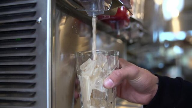 Slow Motion Close-Up Of A Person Pouring A Brown Fountain Drink Into A Glass - Los Angeles, California