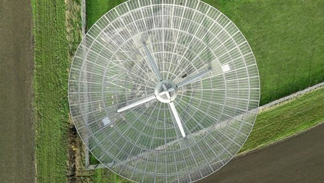 Aerial top-down shot of the modern radiotelescope antenna at the Mullard Radio Astronomy Observatory - CCW rotation ascend