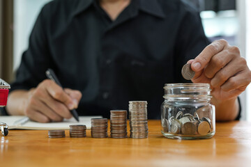 Business man holding light bulb on the Green background nature and writing on note book it for 