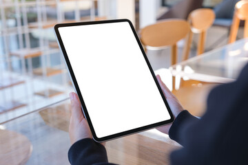 Mockup image of a woman holding digital tablet with blank white desktop screen