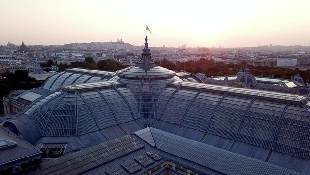 Beautiful aerial shot of architectural wonder, a castle of glass, the Grand Palais, Paris from above at sunrise with Montmartre at horizon. 