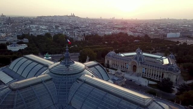 Drone tour of French flag waving on top of the Great palace (Grand palais) and Petit Palais in Paris, France