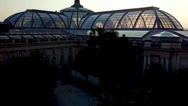 Drone taking flight over historic Travel destination The Grand palais de Paris at sunrise with Paris city in background